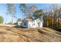 Side view of a white house on a sloped lot at 5747 S Gordon Rd, Austell, GA 30168