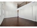 High ceiling living room with hardwood floors and a view to the staircase at 3373 Shoals Ridge Dr, Dacula, GA 30019