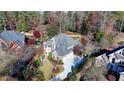 Luxury home nestled in a wooded neighborhood, showcasing its size and curb appeal at 2015 Lake Shore Lndg, Alpharetta, GA 30005