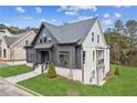 Two-toned farmhouse with gray and white siding, stone path, and landscaping at 108 Cottage Gate Ln, Roswell, GA 30076