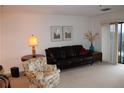 Living area with leather sofa, patterned chair, and balcony access at 300 Johnson Ferry Rd # B802, Atlanta, GA 30328