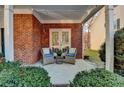 Cozy covered patio with brick flooring and comfortable seating at 2075 Pine Tree Dr # A4, Buford, GA 30518