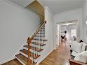 Hardwood staircase with white railings leading to upper level at 2075 Pine Tree Dr # A4, Buford, GA 30518