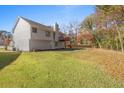 Large backyard with grassy area and a view of the house's back at 5950 Milligan Ct, Atlanta, GA 30349