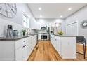 Modern kitchen with white cabinets, granite countertops, and stainless steel appliances at 984 Mcdaniel Sw St, Atlanta, GA 30310