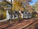 House nestled in wooded area with fall foliage at 3775 Belle Glade Trl, Snellville, GA 30039