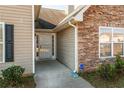 Inviting front entrance with stone and siding details, security system at 2859 High Tide Dr, Atlanta, GA 30349