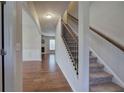 Hardwood floors, staircase with black spindles, and views into the living room at 138 Gorham Gates Dr, Hiram, GA 30141