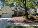 Two-story house with white siding, gray roof, and a two-car garage at 4490 Mariners Rdg, Alpharetta, GA 30005