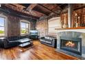 Open living space with hardwood floors, exposed brick, fireplace, and city views at 490 Marietta St # 307, Atlanta, GA 30313