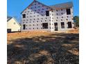 Rear view of two story house under construction, gray roof at 1128 E Shoreview Rd, Mcdonough, GA 30253