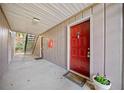 Red front door of a condo with a staircase to the side at 4065 Woodridge Way, Tucker, GA 30084