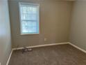 Simple bedroom with carpeted floor and window at 3506 Ten Oaks Ct, Powder Springs, GA 30127