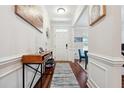 Entryway with hardwood floors, console table, and view into living room at 2599 Windsor Knoll Dr, Dacula, GA 30019