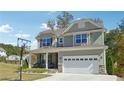 Two-story house with basketball goal, gray siding, stone accents, and a white garage door at 2599 Windsor Knoll Dr, Dacula, GA 30019