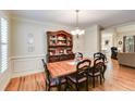 Formal dining room featuring hardwood floors, a wooden table, and built-in hutch at 1058 Magnolia Dr, Villa Rica, GA 30180