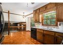 Kitchen with wood cabinets, granite counters, and view to Gathering room at 3409 Shorelake Dr, Tucker, GA 30084