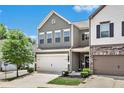 Two-story townhome with gray siding and a two-car garage at 504 Crescent Woode Dr, Dallas, GA 30157