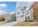 Two-story house with gray siding, white garage door, and American flag at 78 Hiram Park Ct, Hiram, GA 30141