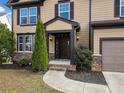 Dark brown front door, stone accents, and landscaping at 904 Berry Ct, Canton, GA 30114