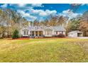 House exterior showcasing a large yard and detached workshop at 4120 Grady Smith Rd, Loganville, GA 30052