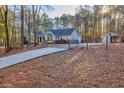 Ranch home with long driveway, fenced yard, and detached workshop at 4120 Grady Smith Rd, Loganville, GA 30052