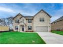 Two story brick home with attached garage and manicured lawn at 2376 Cadenza Cir, Dacula, GA 30019