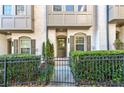 Townhome entrance with walkway, landscaping, and black iron fence at 633 Broadview Pl, Atlanta, GA 30324