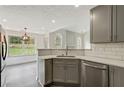 Modern kitchen with gray cabinets, white quartz countertops, and stainless steel appliances at 539 Easton Dr, Locust Grove, GA 30248