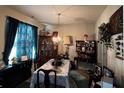 Formal dining room with a table, chairs, and display cabinets at 6599 Woodwell Dr, Union City, GA 30291