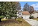 Two-story house with a two-car garage and mature trees at 700 Mountain Oaks Pkwy, Stone Mountain, GA 30087