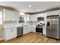 Modern kitchen with white cabinets, stainless steel appliances, and quartz countertops at 2485 Brentwood Rd, Decatur, GA 30032