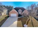 Two-story brick house with a large yard and driveway at 3125 Esplanade Sw Cir, Atlanta, GA 30311