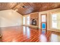 Living room features hardwood floors, a fireplace, and a unique ceiling at 138 Mcdonald Rd, Covington, GA 30014