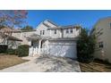 Two-story house with gray siding, white garage door, and landscaping at 2786 Alix Way, Lithia Springs, GA 30122