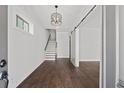 Bright entryway with hardwood floors, staircase, and barn door at 4002 Moody Ln, Woodstock, GA 30188
