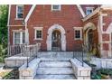 Front porch detail with arched entryway and brick columns at 1225 Clifton Rd, Atlanta, GA 30307