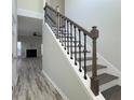 Elegant staircase with wrought-iron balusters and dark wood steps at 2936 Winter Rose Ct, Atlanta, GA 30360