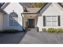 Welcoming front entrance with black door and white brick accents at 1413 Wilkes Crest Ct, Dacula, GA 30019