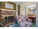 Brick fireplace with gold mirror and built-in shelving in living room at 3632 Glen Mora Dr, Decatur, GA 30032