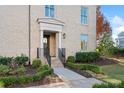 Welcoming front entrance with a classic portico, steps, and manicured landscaping at 152 Grand Cres, Alpharetta, GA 30009
