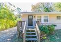 House exterior featuring a dark brown front door and wooden steps leading to a porch at 1777 W Austin Rd, Decatur, GA 30032