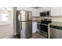 Stainless steel appliances and granite countertops in this updated kitchen at 1777 W Austin Rd, Decatur, GA 30032