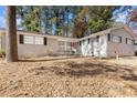 Ranch house with red front door and mature trees at 1961 Austin Sw Rd, Atlanta, GA 30331