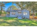 Charming bungalow with gray siding, landscaped lawn, and a welcoming front porch at 1676 Sylvan Sw Rd, Atlanta, GA 30310