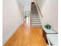 Light-filled entryway with hardwood floors and staircase leading upstairs at 2252 Edgartown Se Ln # 2, Smyrna, GA 30080