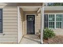 Dark gray front door with a glass panel and sidelights at 7133 Pineview Sw Dr, Covington, GA 30014