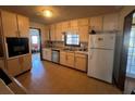 Galley kitchen with light cabinets and granite countertops at 4660 Sundridge Trl, Fairburn, GA 30213