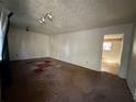 Spacious living room with large window and worn carpet at 8423 Avalon Dr, Riverdale, GA 30274