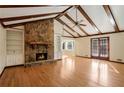 Living room with hardwood floors, stone fireplace, and built-in shelving at 5438 Chanel Ct, Atlanta, GA 30338